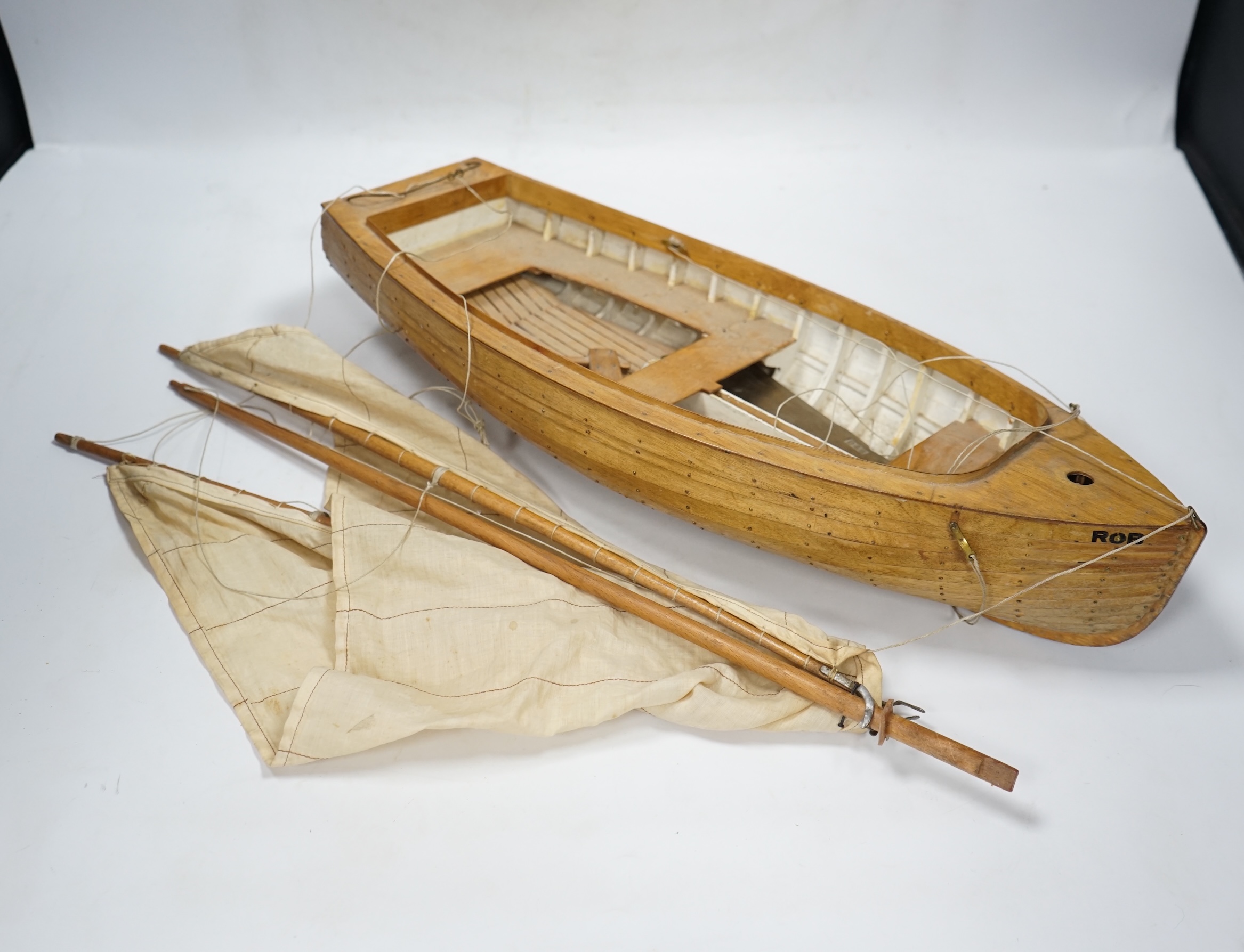 A mid 20th century kit built wooden model sailing boat, ‘Rob’, of plank on frame construction with white painted interior, hull 45cm long. Condition - fair to good.